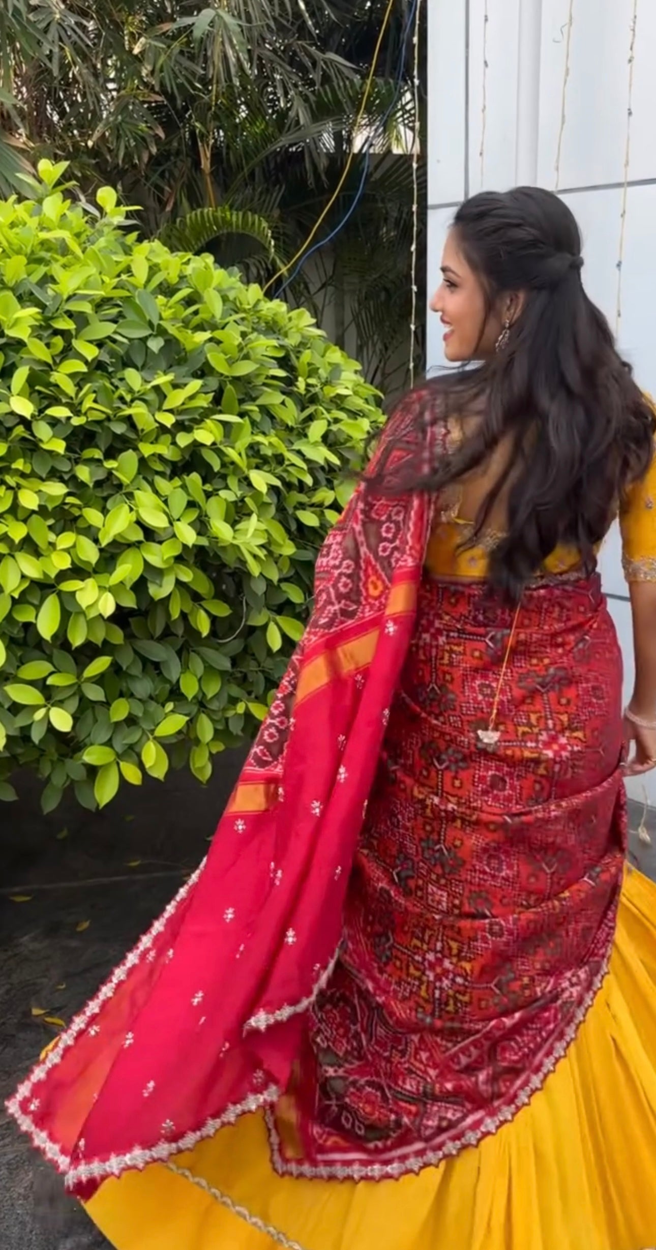 Elegant yellow Raw Silk Lehenga with  maroon Ikkat Patan Patola Dupatta and Maggam Blouse